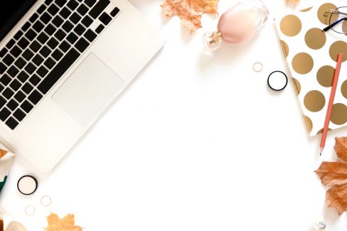 Laptop, cosmetics, notebook on white background